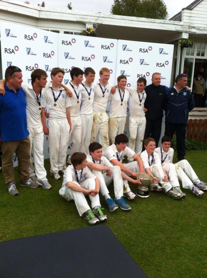 Image of youth members with medals along side coaches