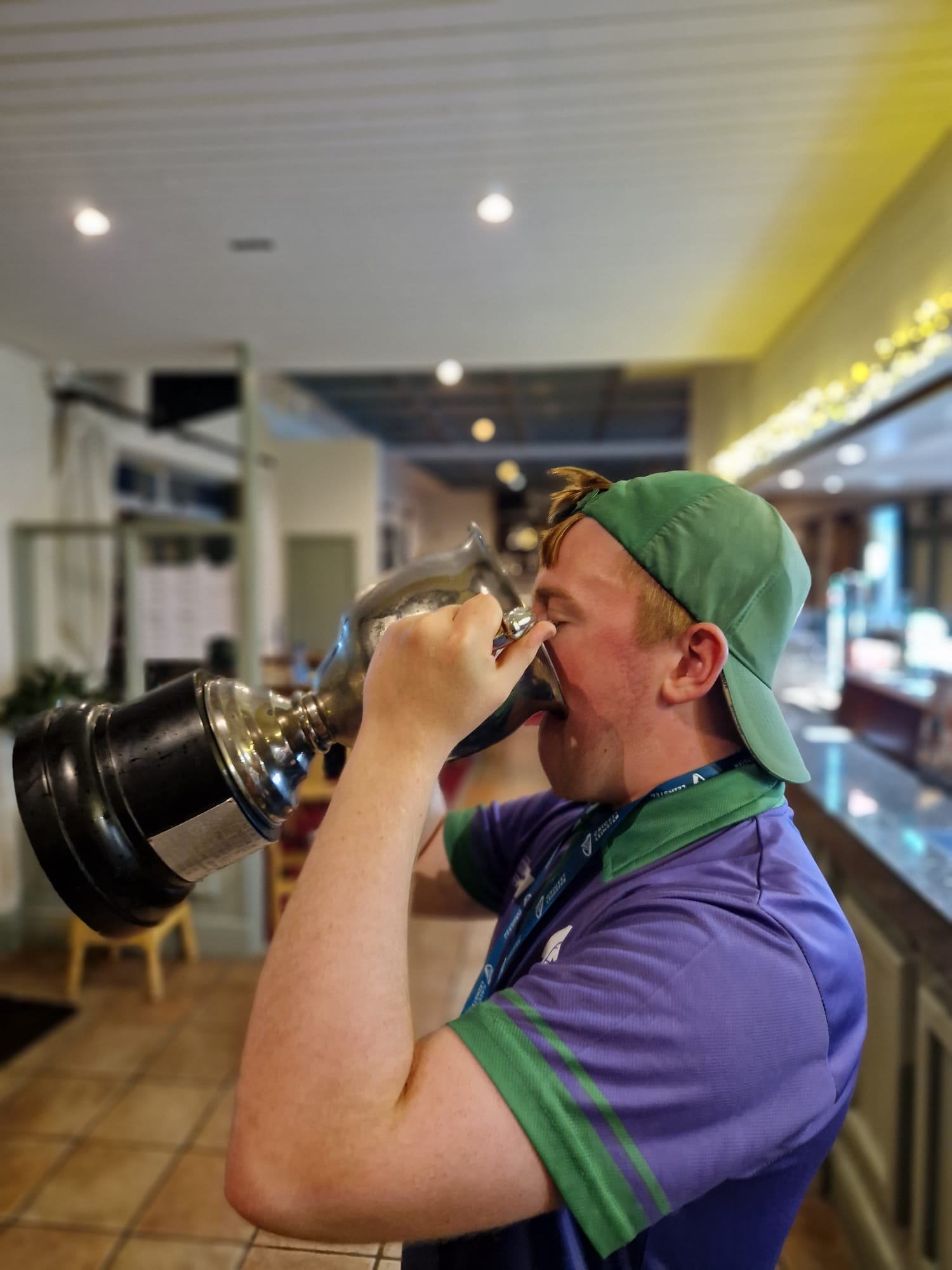 Image of a player drinking from the trophy