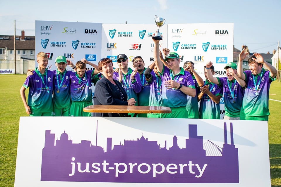 Image of 4ths team celebrating with captain holding a trophy